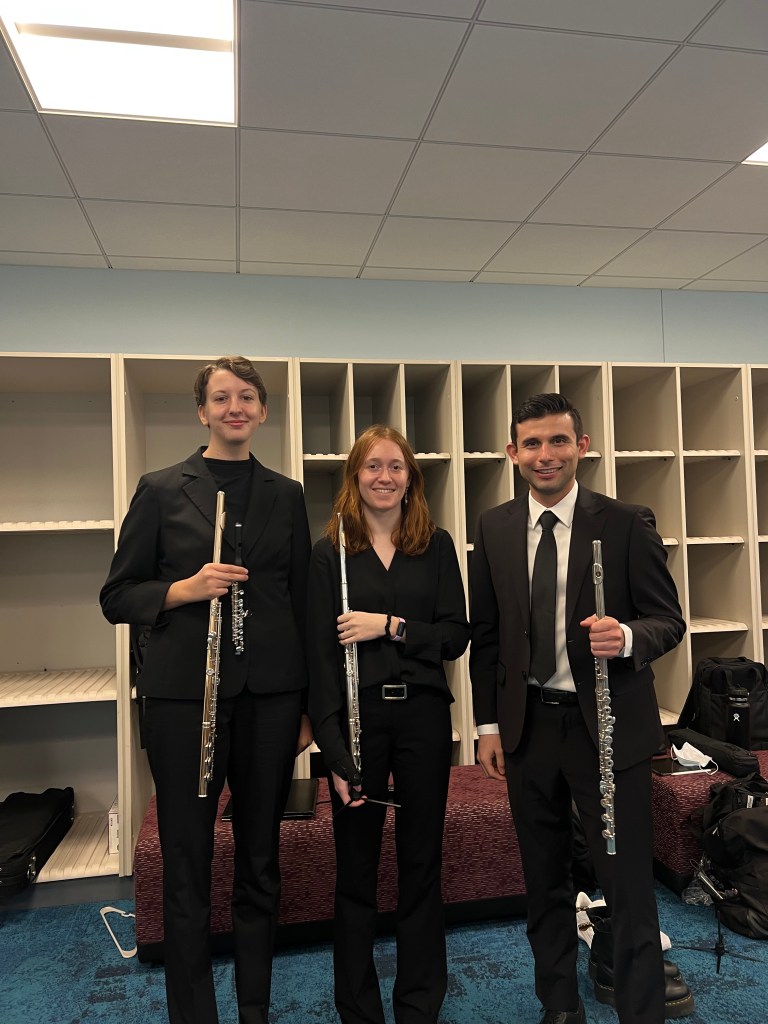 Sydney with two other flutists in dress clothes.