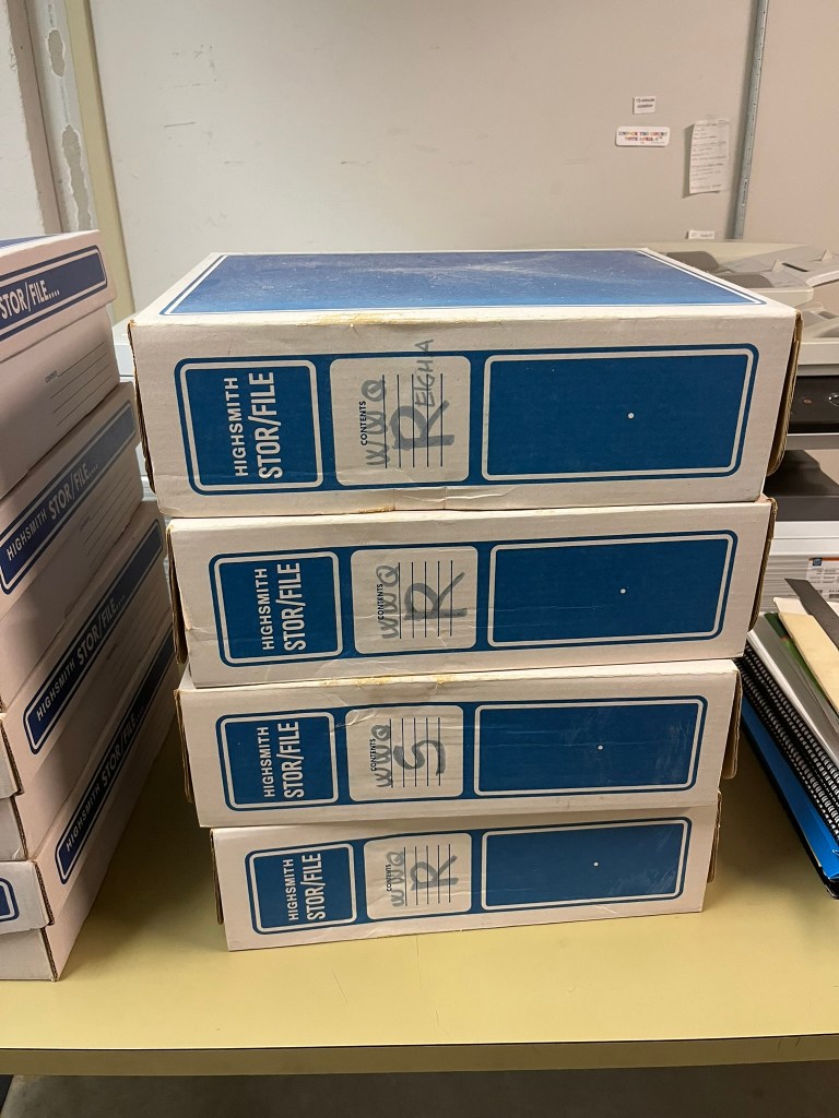 Photo of blue and white cardboard boxes from Wingra Quintet Library.